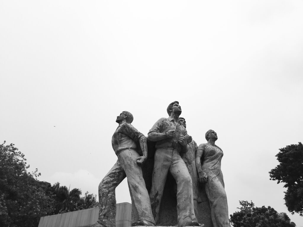Black and white image of the Raju Memorial Sculpture at Dhaka University symbolizing resilience.